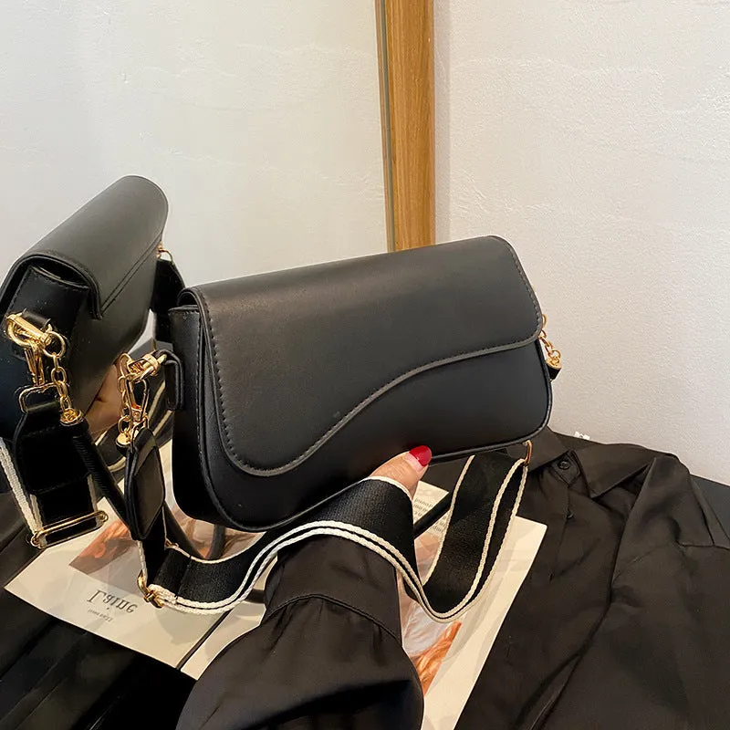 Retro women's messenger bag in black PU leather with horizontal square shape and double shoulder straps.