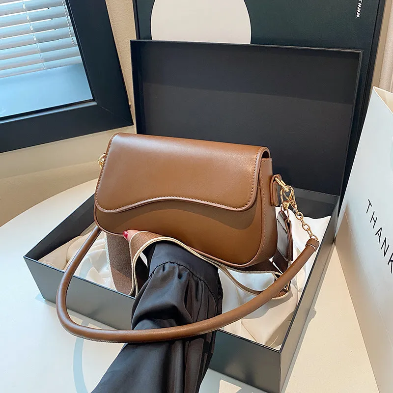 Retro women's messenger bag in black PU leather with horizontal square shape and double shoulder straps.