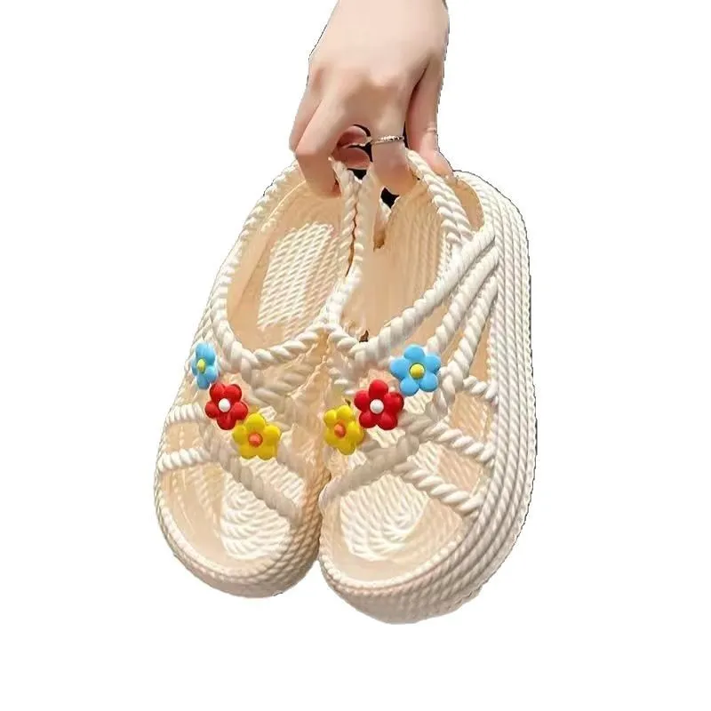 Women's PVC sandals with flower decorations in beige and black colours showing round-toe non-slip design