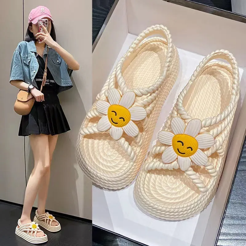 Women's PVC sandals with flower decorations in beige and black colours showing round-toe non-slip design