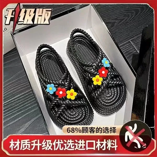 Women's PVC sandals with flower decorations in beige and black colours showing round-toe non-slip design