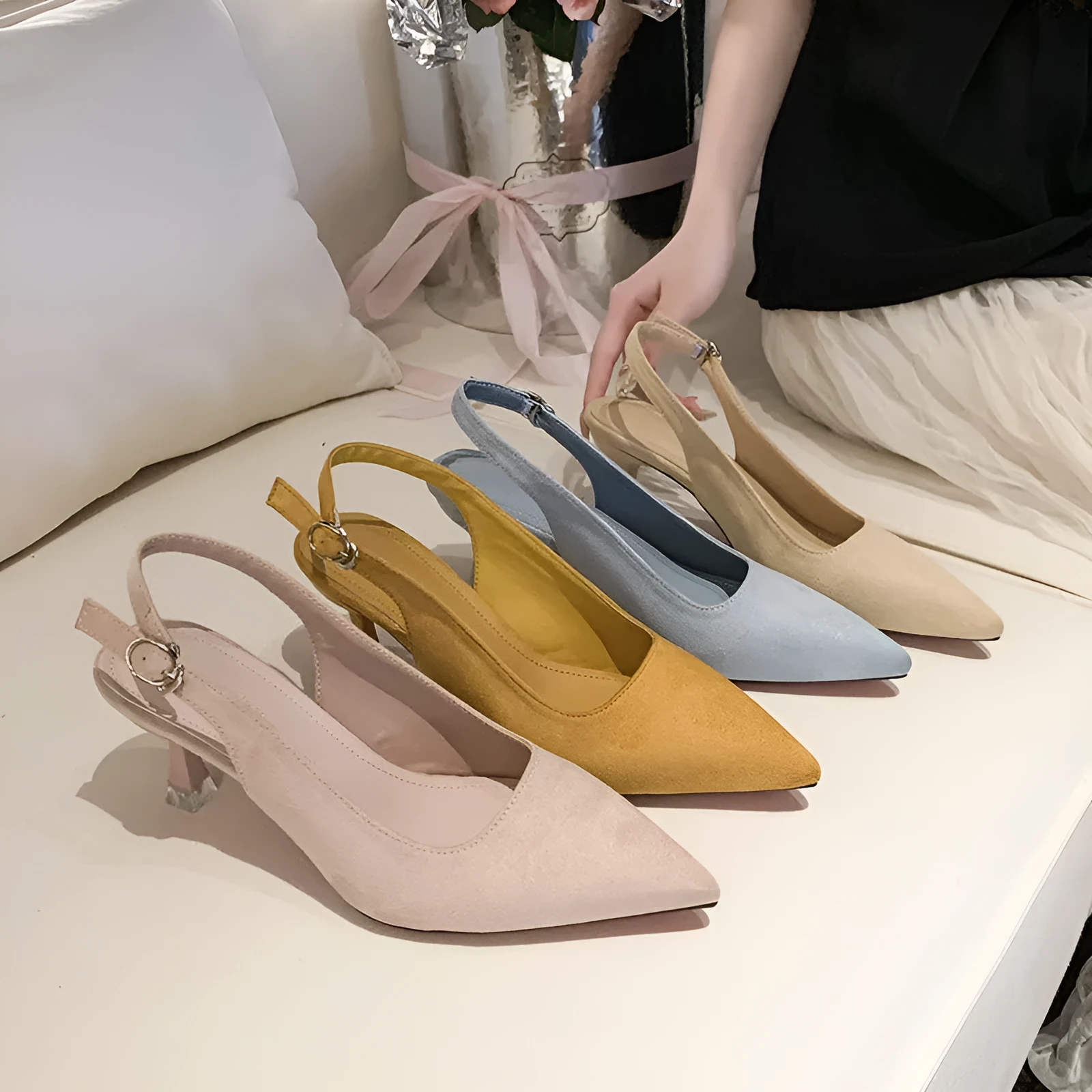 A pair of apricot-coloured suede pointed-toe stiletto high heels with a rubber sole.