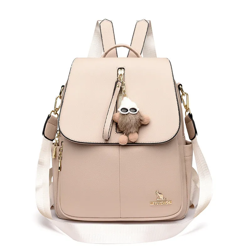 Genuine leather backpack with pendant and spliced belt detail for students and travellers, available in beige