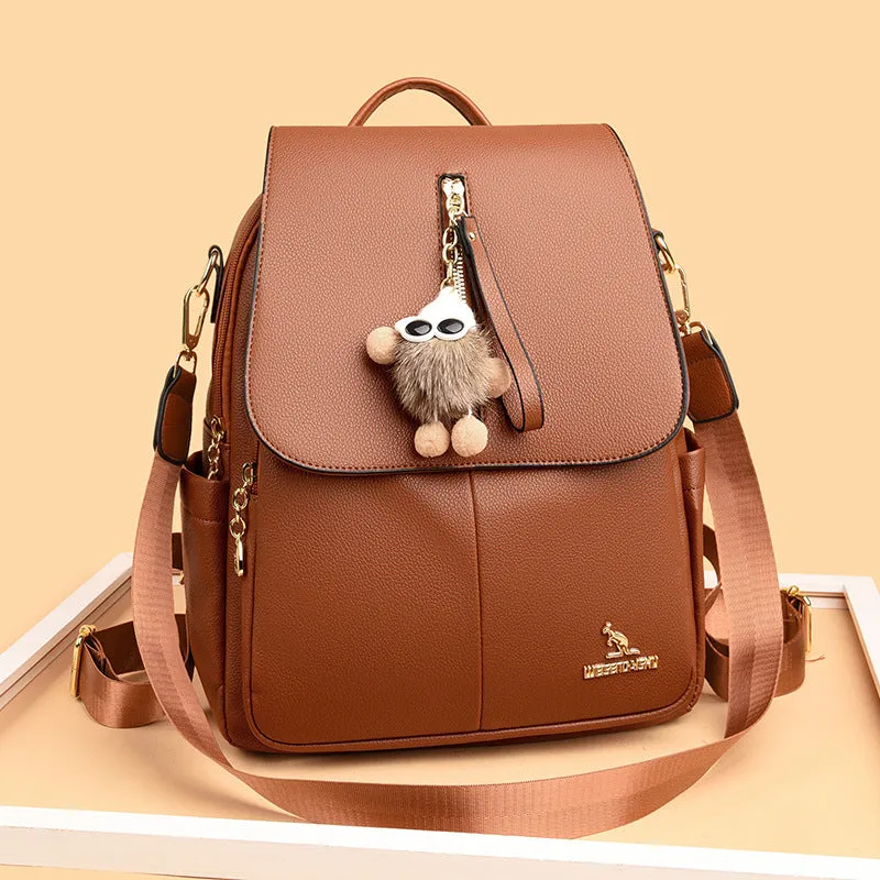 Genuine leather backpack with pendant and spliced belt detail for students and travellers, available in beige
