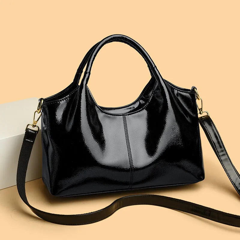 Genuine leather commuter bag with glossy finish, belt decoration, and leather grain in a horizontal square shape
