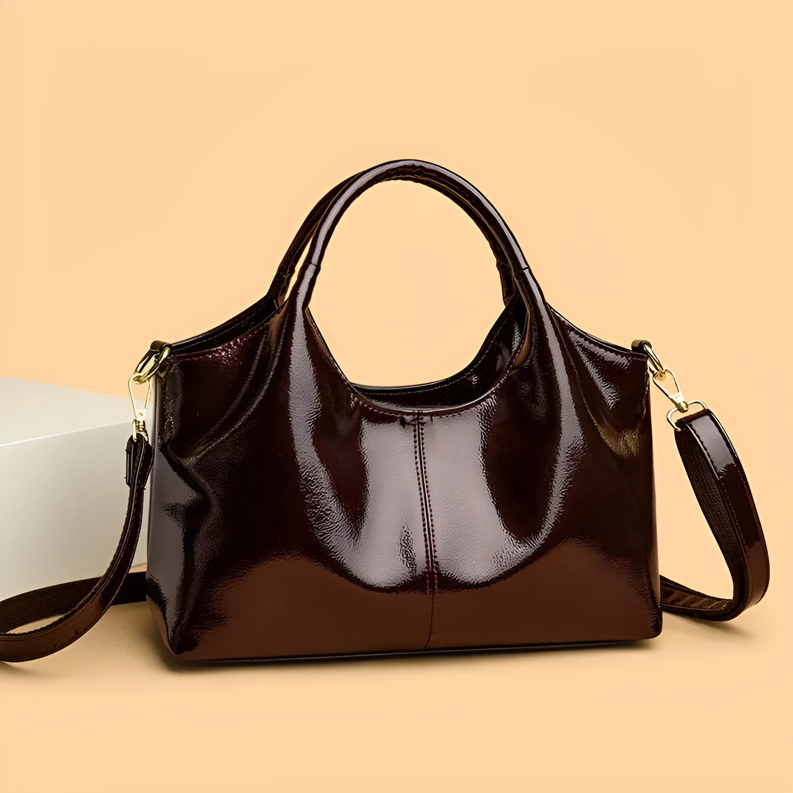 Genuine leather commuter bag with glossy finish, belt decoration, and leather grain in a horizontal square shape