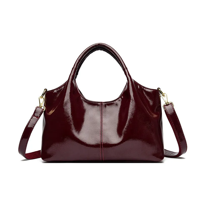 Genuine leather commuter bag with glossy finish, belt decoration, and leather grain in a horizontal square shape