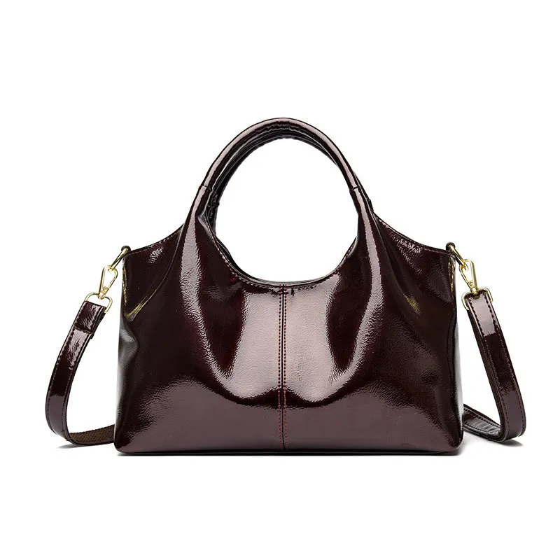 Genuine leather commuter bag with glossy finish, belt decoration, and leather grain in a horizontal square shape