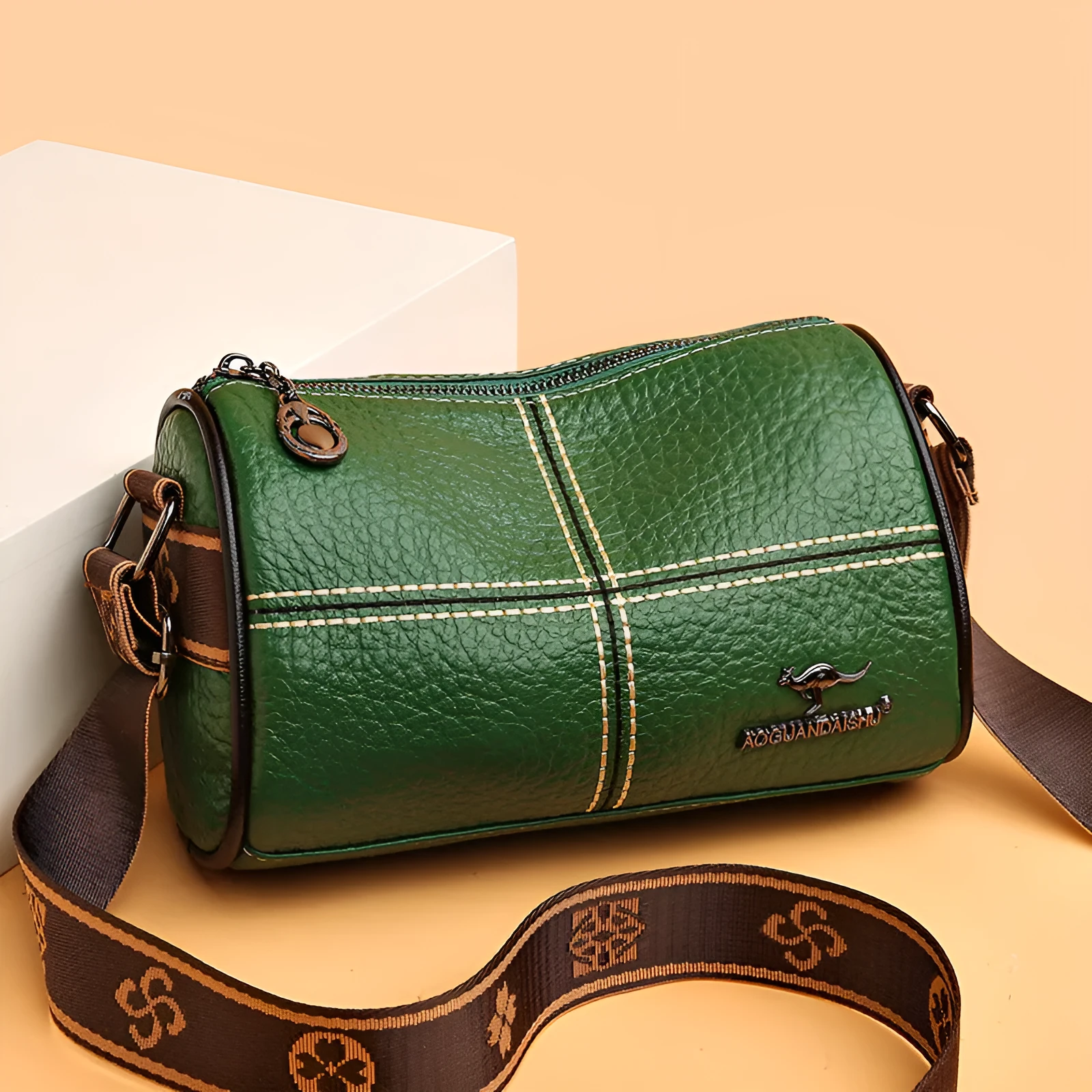 Women's casual stitched genuine leather shoulder bag in cylindrical shape, available in black, brown, green, and white