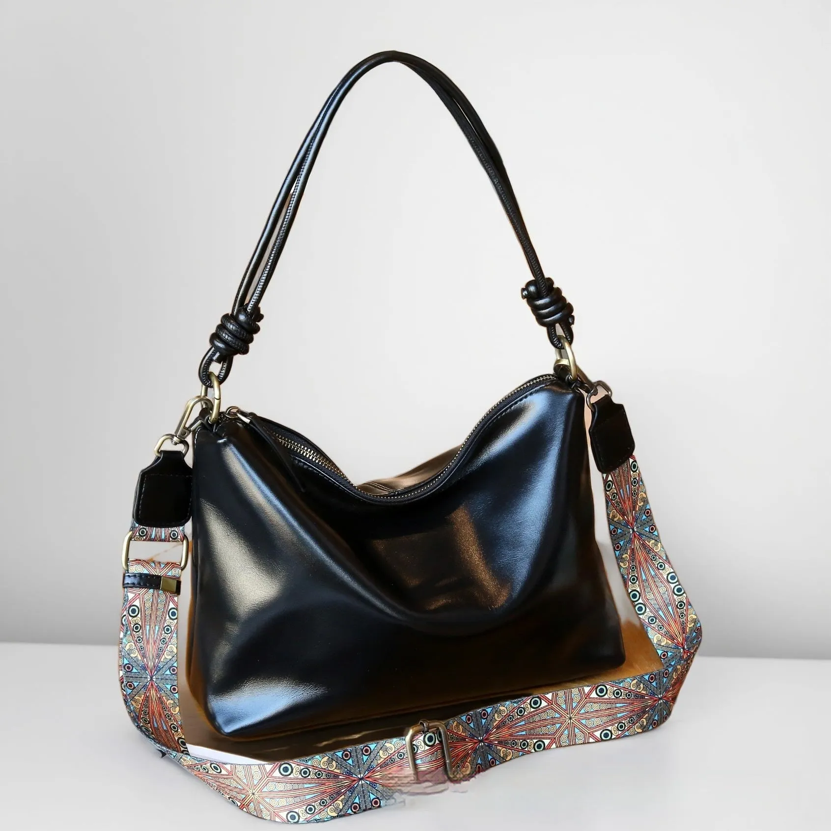 Genuine leather creative large capacity pillow-shaped shoulder bag in black with double straps and top grain leather finish