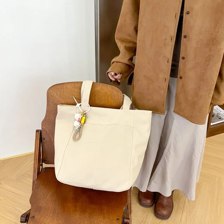 Canvas casual large capacity shoulder bag for women in four colours with pendant options