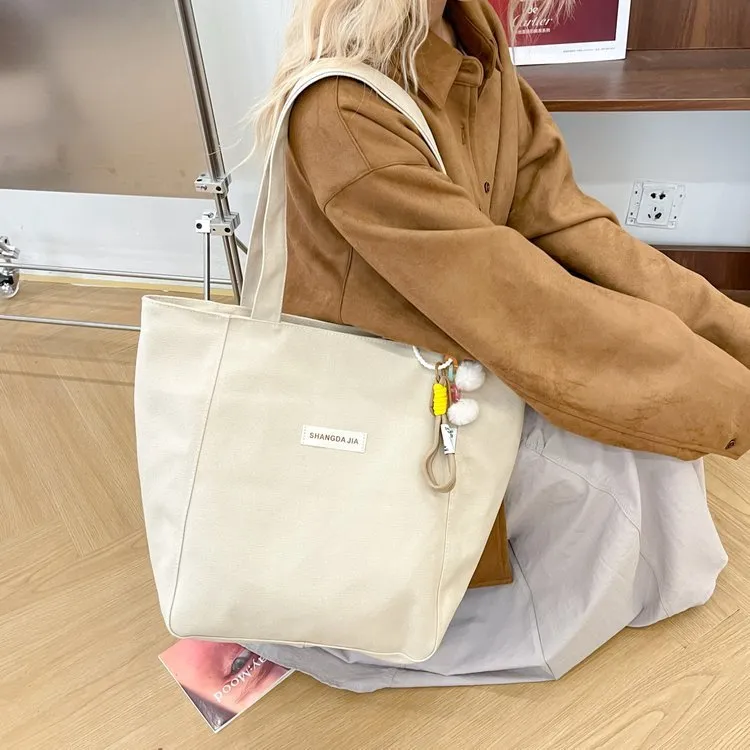 Canvas casual large capacity shoulder bag for women in four colours with pendant options