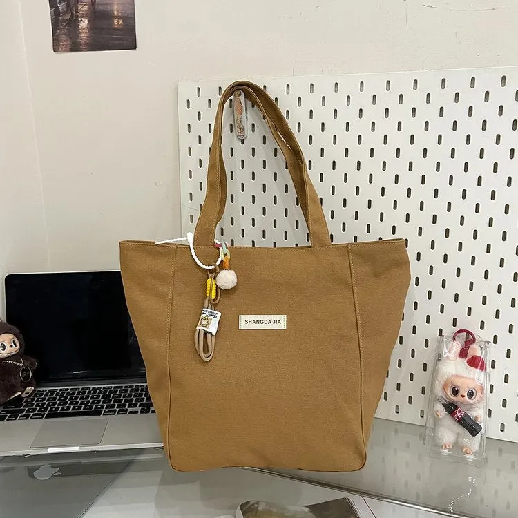 Canvas casual large capacity shoulder bag for women in four colours with pendant options