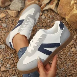 Blue women's low-top hiking training shoes with a lace-up front and rubber sole.