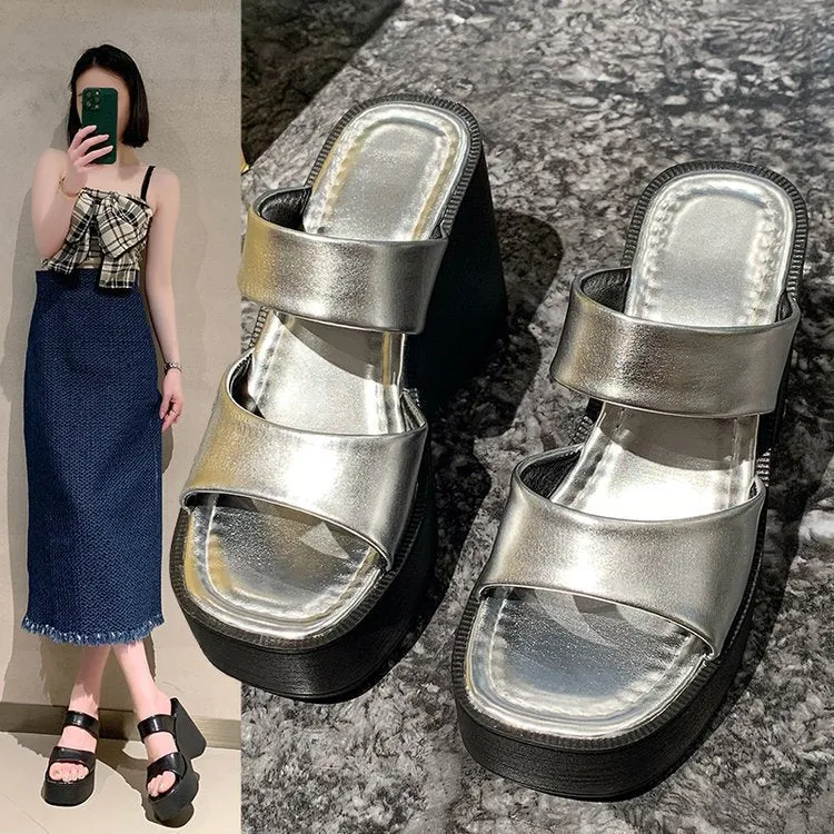 Women's black wedge platform slippers with square toe on a white background.