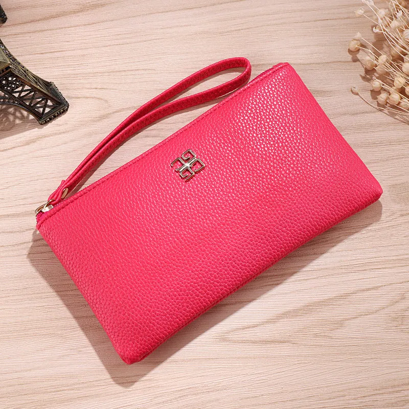Long 55-inch PU leather zip wallet handbag in a solid colour with sewing line detail.