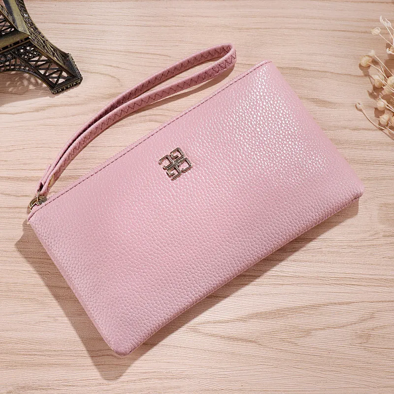 Long 55-inch PU leather zip wallet handbag in a solid colour with sewing line detail.