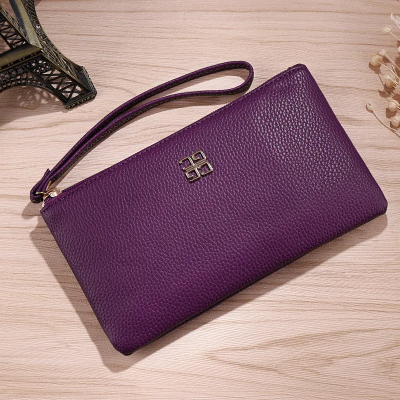 Long 55-inch PU leather zip wallet handbag in a solid colour with sewing line detail.