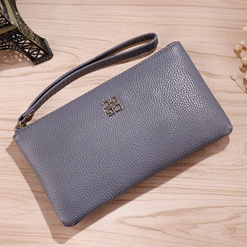 Long 55-inch PU leather zip wallet handbag in a solid colour with sewing line detail.