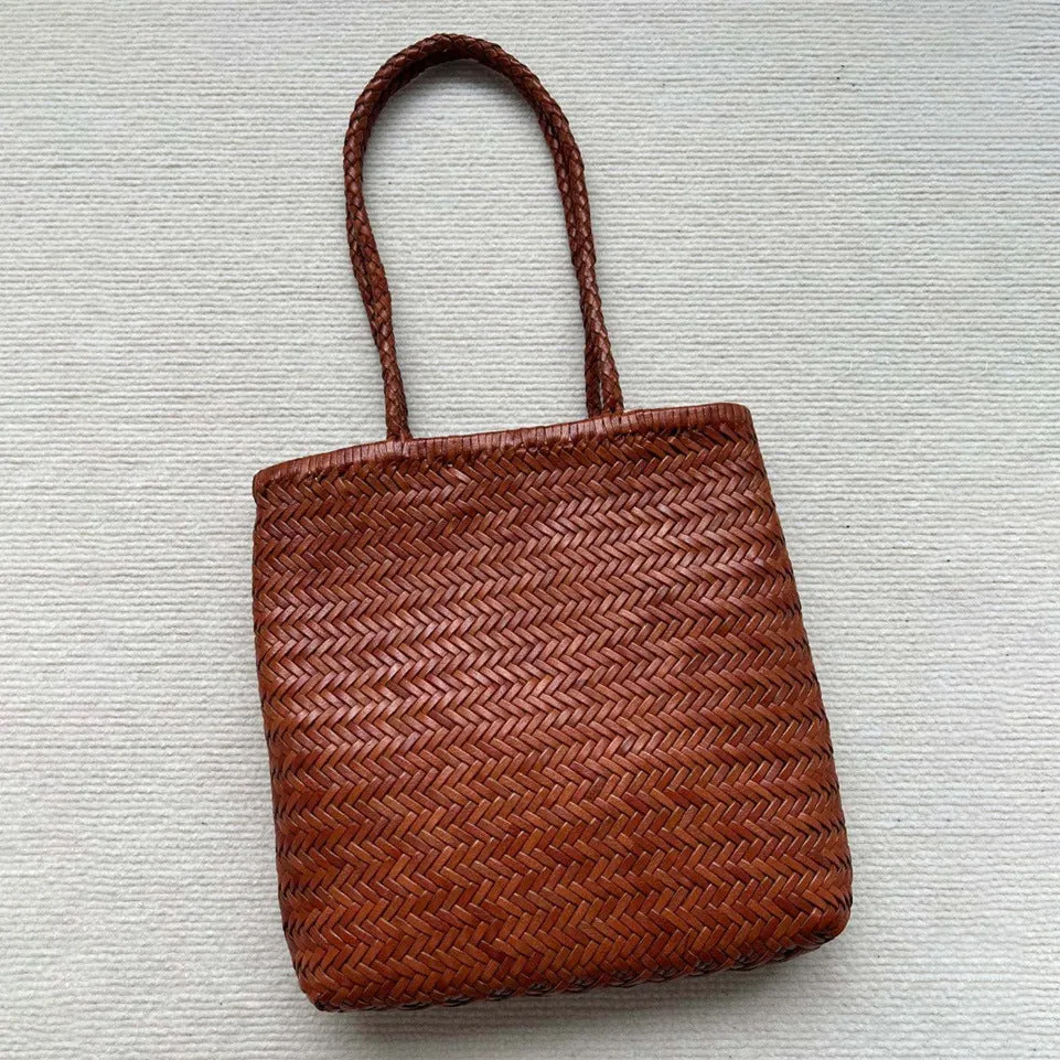Handmade brown woven cowhide leather tote bag with a structured front pocket.