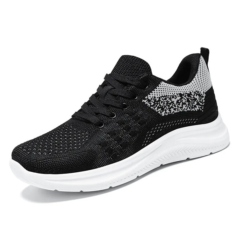 Women's low-top lace-up sneakers in black mesh with a soft PVC sole.