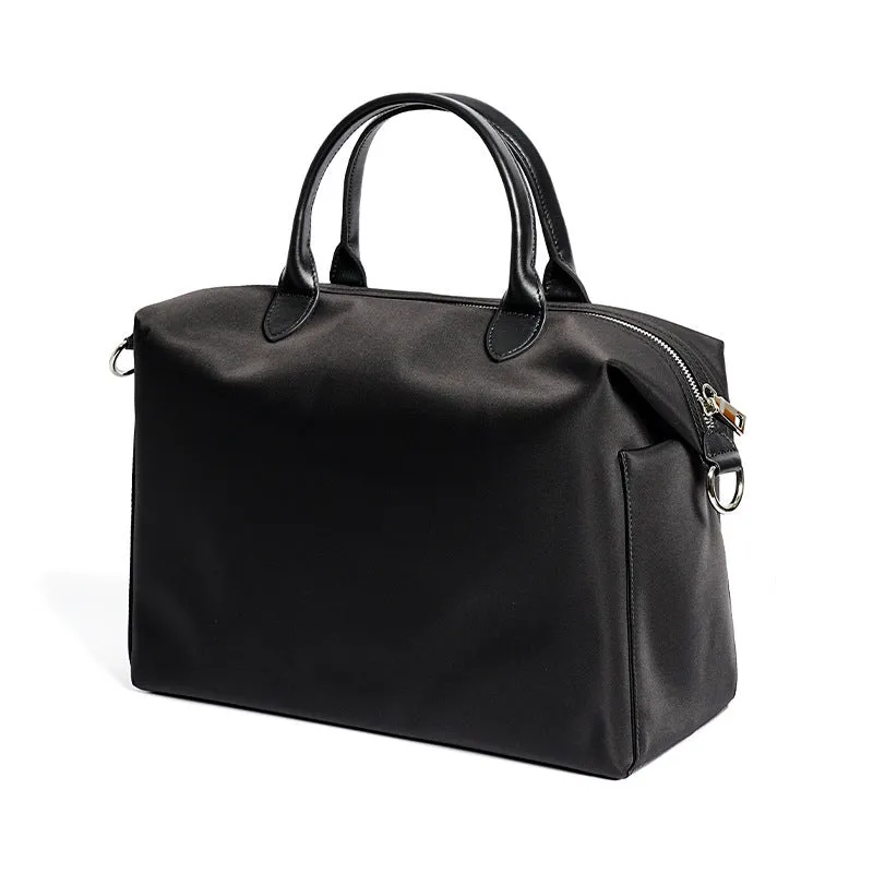 Black nylon waterproof shoulder bag with leather trim, showing large main compartment and shoulder strap.