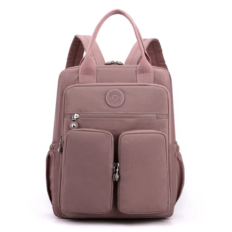 Large soft nylon waterproof backpack in grey, open to show internal laptop, camera, and phone compartments.
