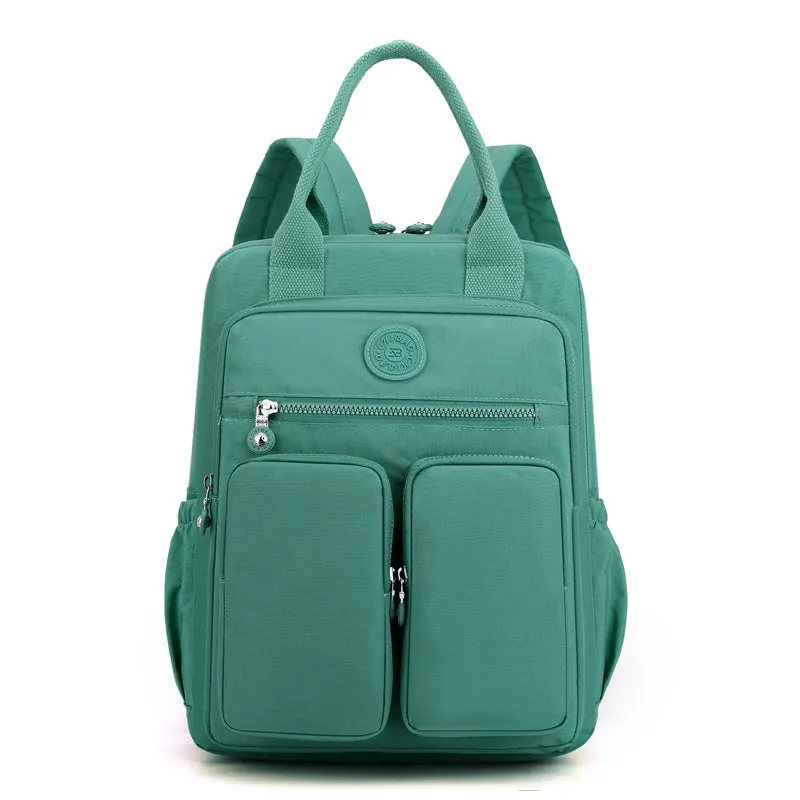 Large soft nylon waterproof backpack in grey, open to show internal laptop, camera, and phone compartments.
