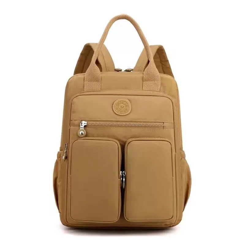 Large soft nylon waterproof backpack in grey, open to show internal laptop, camera, and phone compartments.