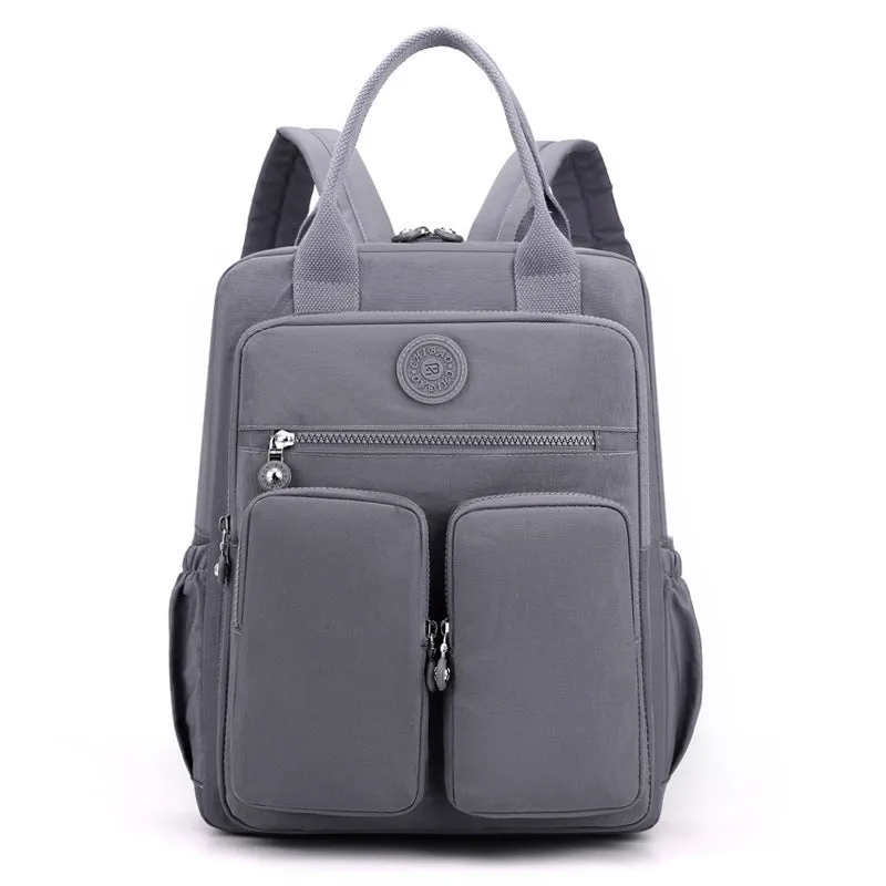 Large soft nylon waterproof backpack in grey, open to show internal laptop, camera, and phone compartments.