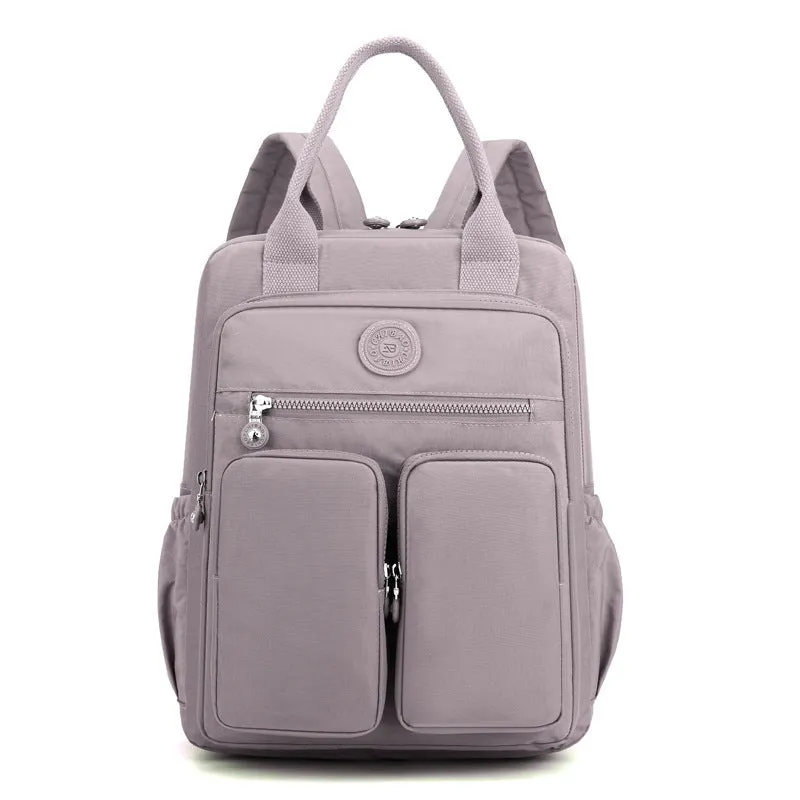 Large soft nylon waterproof backpack in grey, open to show internal laptop, camera, and phone compartments.