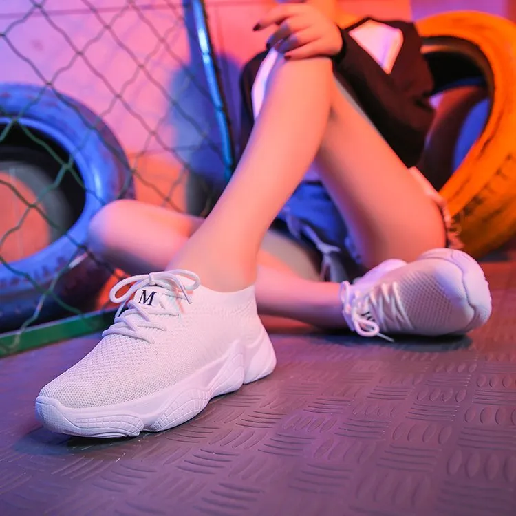 White thick-soled women's flyknit trainers with front strap and rubber sole.