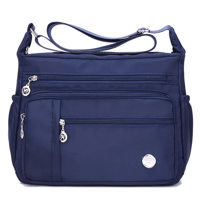 Lightweight nylon women's one shoulder crossbody bag in black with horizontal square shape and visible sewing thread detail