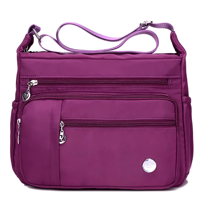 Lightweight nylon women's one shoulder crossbody bag in black with horizontal square shape and visible sewing thread detail