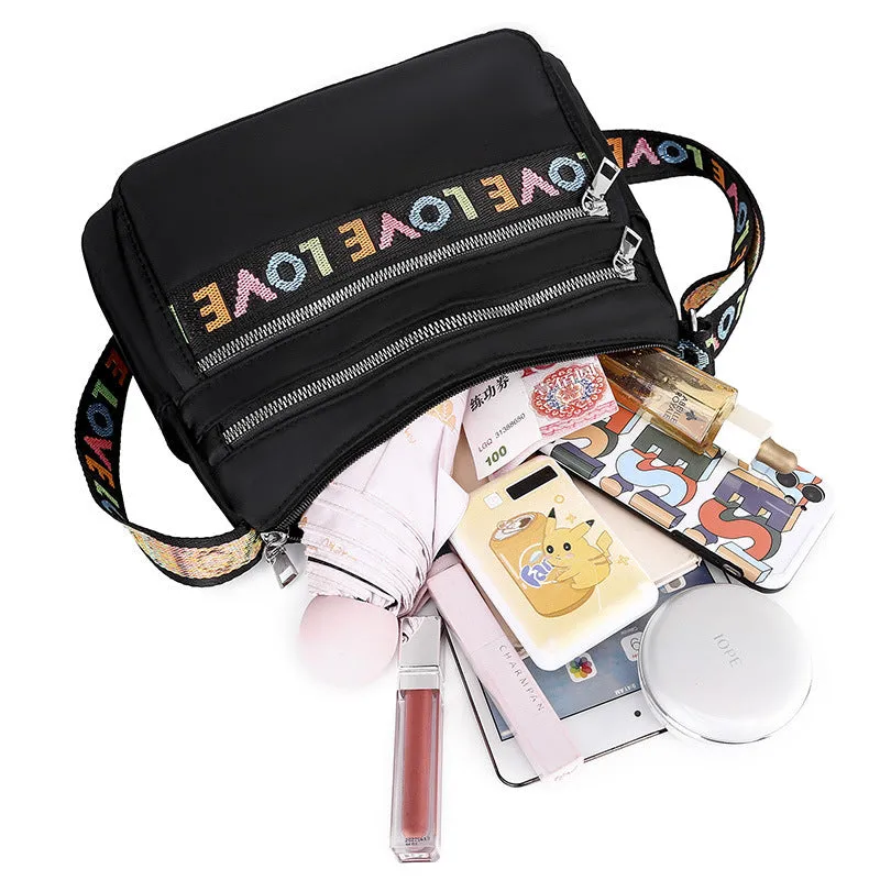 Soft oxford cloth crossbody shoulder bag with multiple pockets, letter stitching, available in black and red