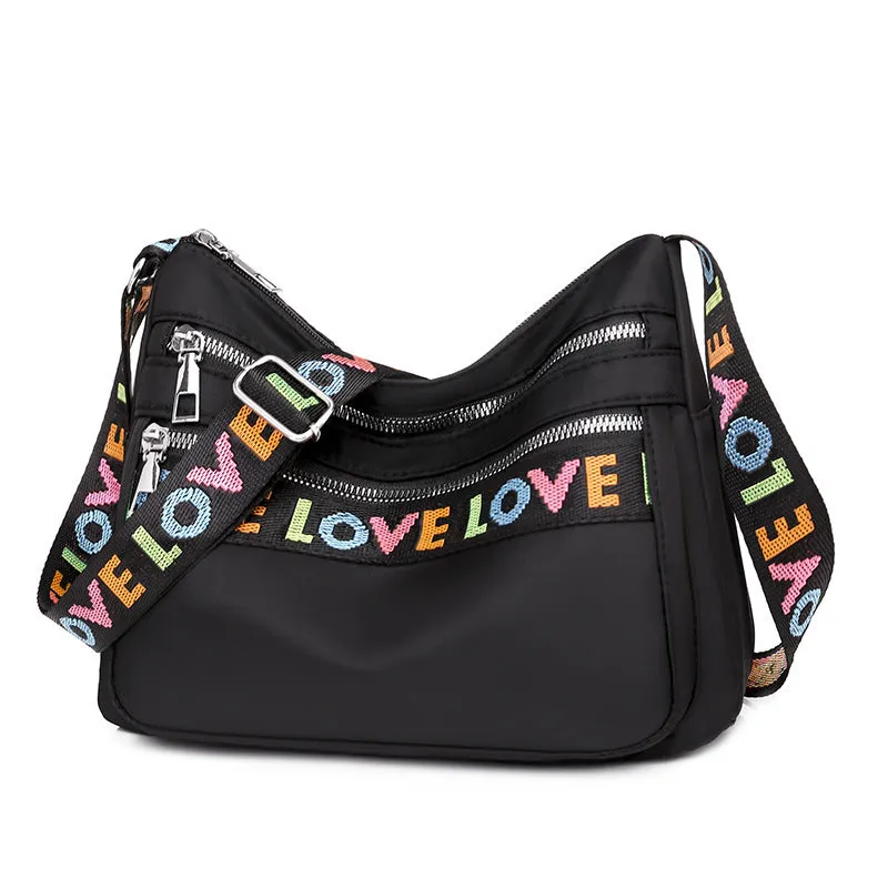 Soft oxford cloth crossbody shoulder bag with multiple pockets, letter stitching, available in black and red