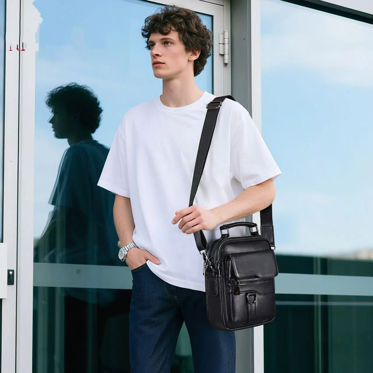 Black genuine first layer cowhide leather messenger bag measuring 19x8x24cm with slung strap