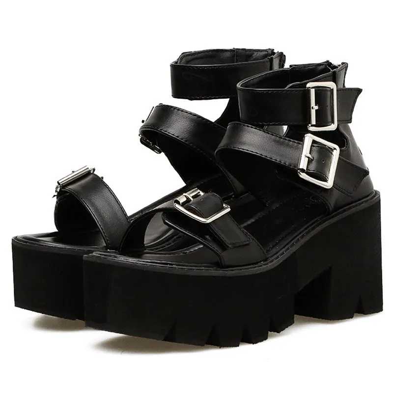 Black punk-style women's sandals with a thick chunky heel, round toe, buckle detail and back zipper.