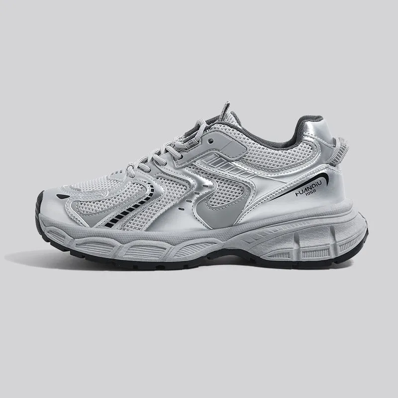 Grey chunky platform sneakers with leather stitching and lace-up design on a white background.