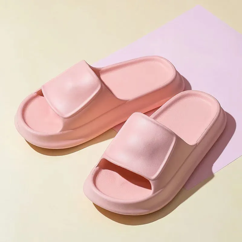 Pair of thick-soled EVA flip-flop slippers in a chosen colour on a bathroom floor.
