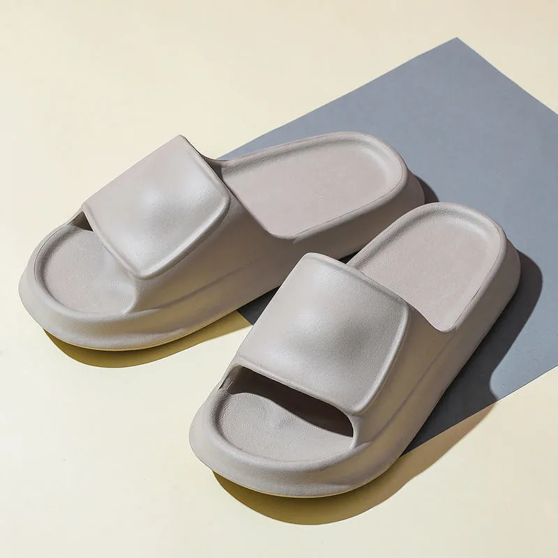 Pair of thick-soled EVA flip-flop slippers in a chosen colour on a bathroom floor.