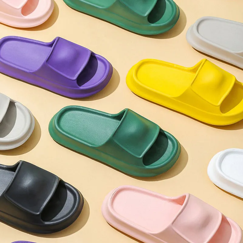 Pair of thick-soled EVA flip-flop slippers in a chosen colour on a bathroom floor.