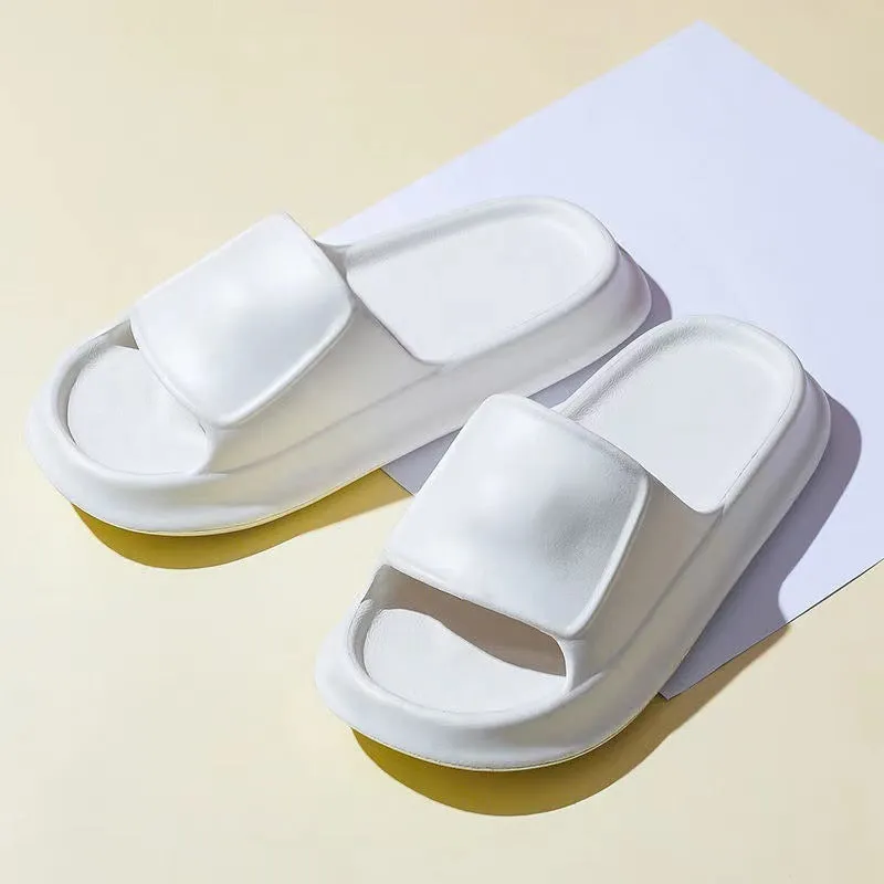 Pair of thick-soled EVA flip-flop slippers in a chosen colour on a bathroom floor.
