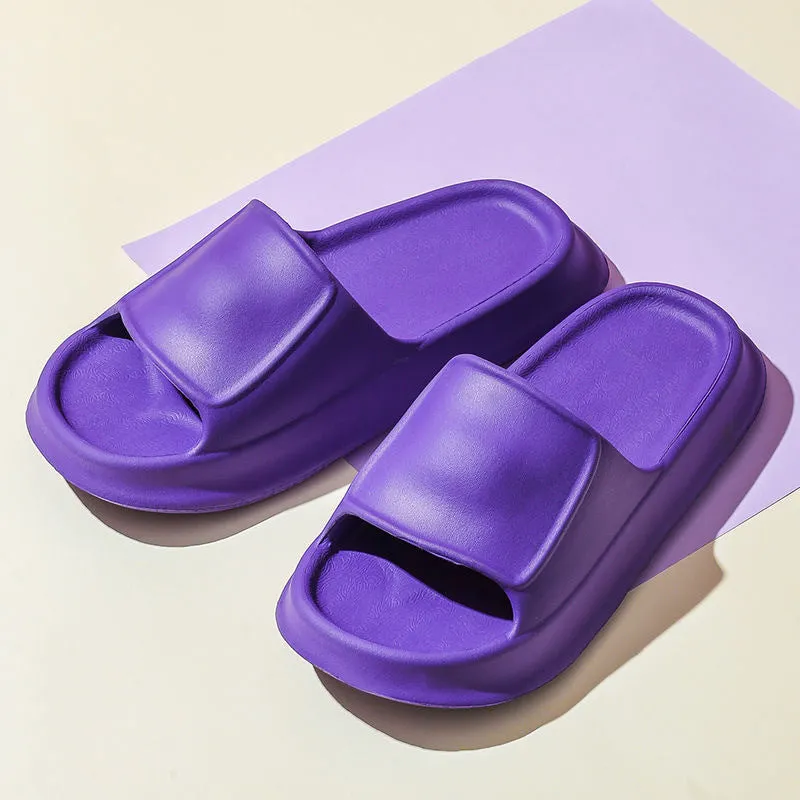 Pair of thick-soled EVA flip-flop slippers in a chosen colour on a bathroom floor.