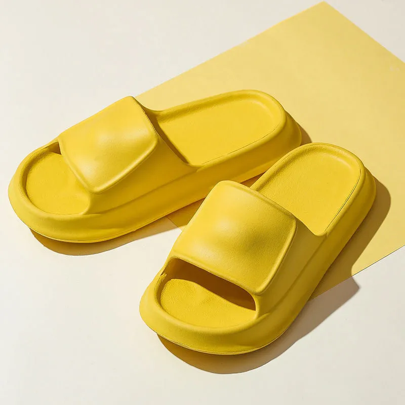 Pair of thick-soled EVA flip-flop slippers in a chosen colour on a bathroom floor.