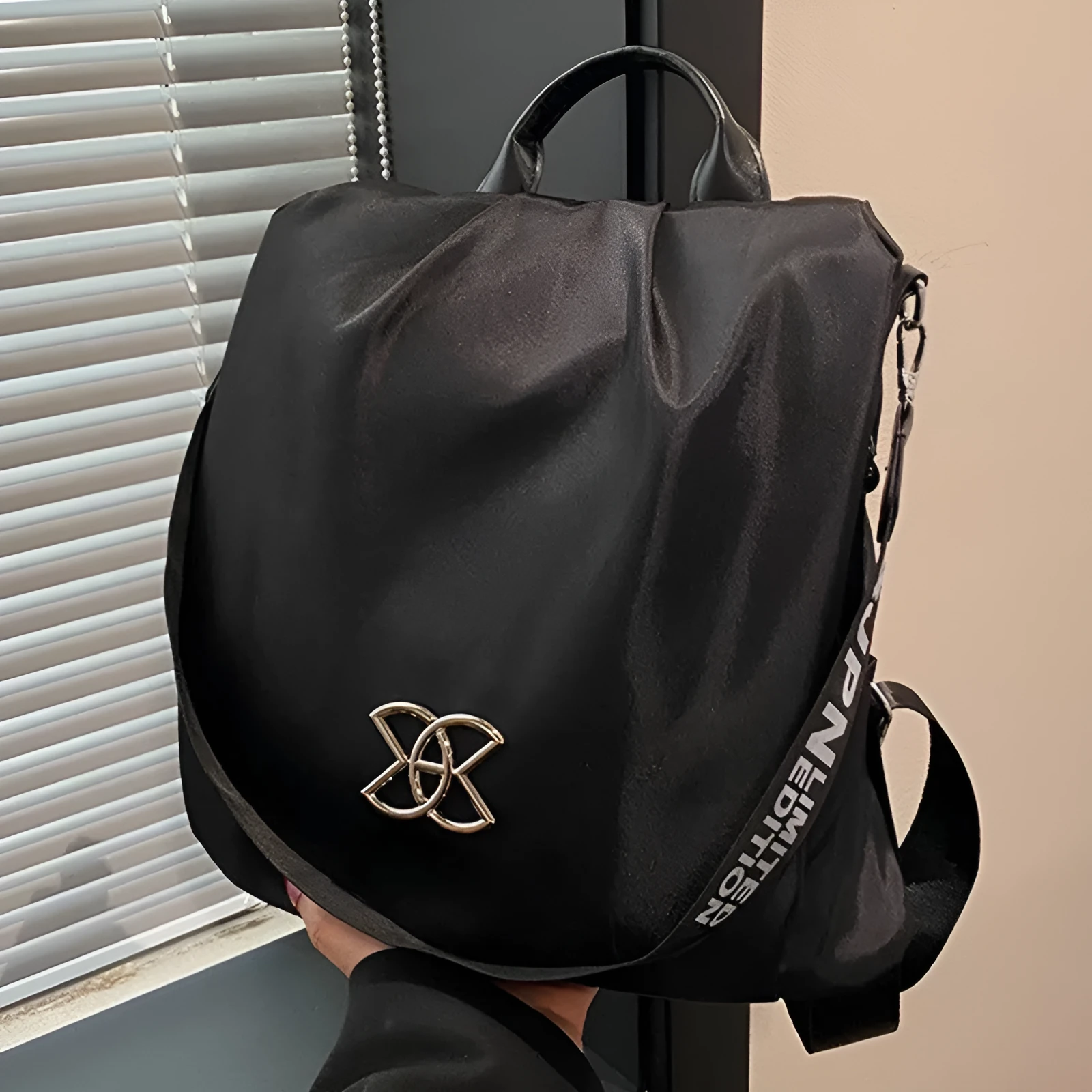 Women's black travel backpack with contrast stitching, large capacity, and three-dimensional outer pocket