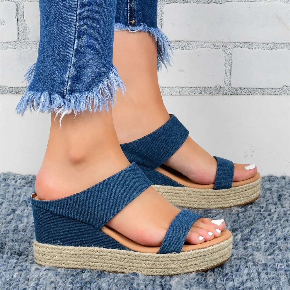Women's wedge heel slippers in white with hollow design, round toe, and rubber sole