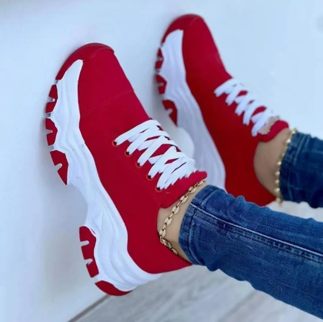 Women's platform lace-up sneaker with rubber sole, round toe, and thick platform in solid red colour