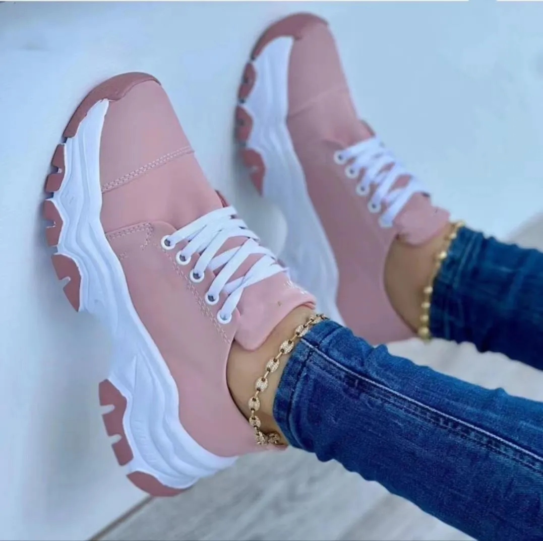 Women's platform lace-up sneaker with rubber sole, round toe, and thick platform in solid red colour