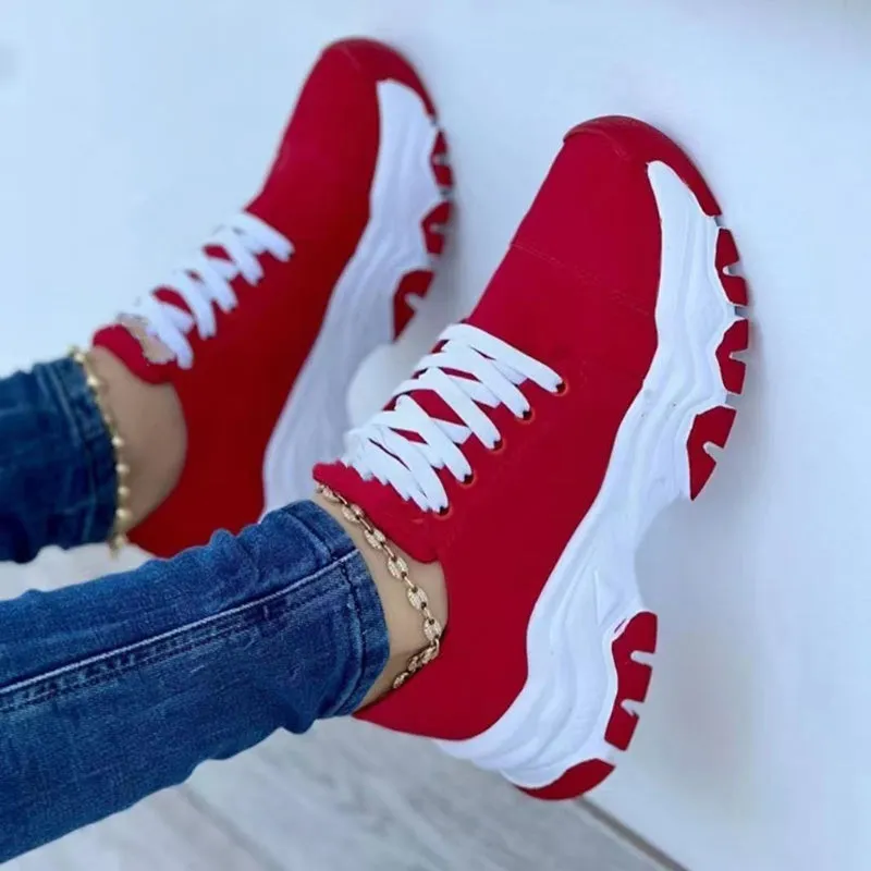 Women's platform lace-up sneaker with rubber sole, round toe, and thick platform in solid red colour